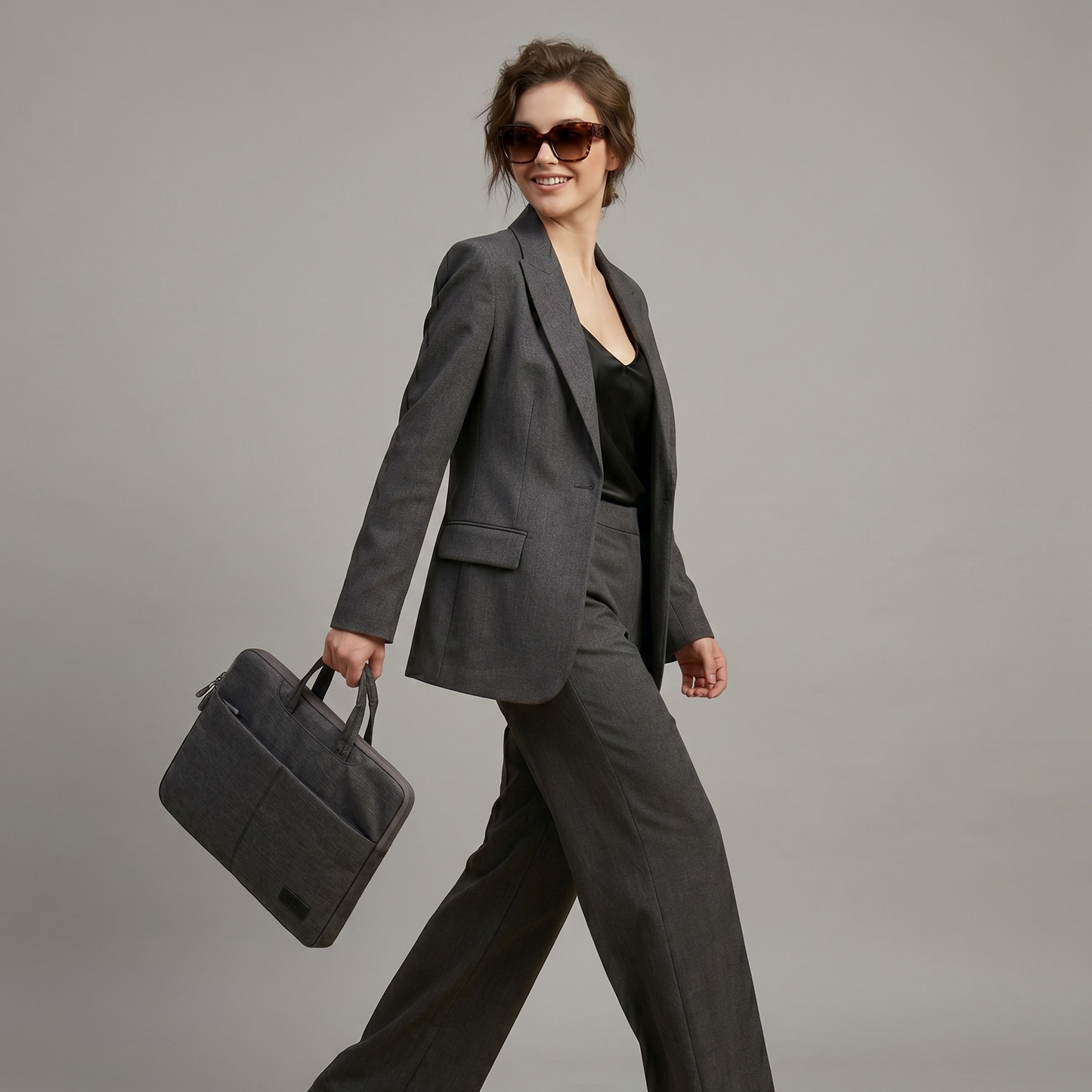 Minimalist Executive Core laptop bag in black and grey, water-resistant oxford fabric with padded laptop compartment and luggage strap.