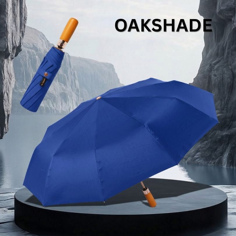 OakShade NertZ.in blue umbrella, open and closed, on a dark grey pedestal with a water and cliff background