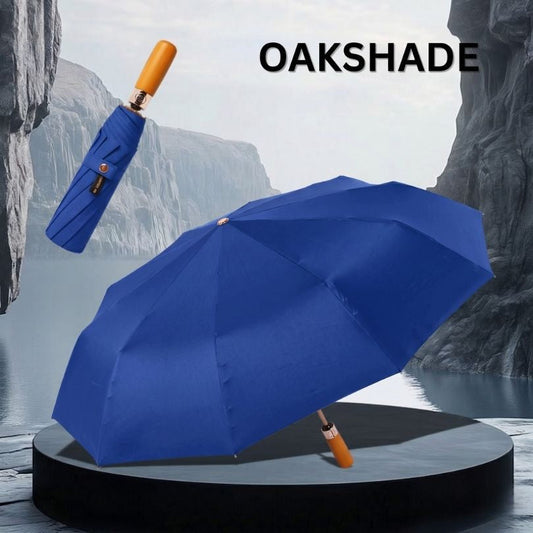 OakShade NertZ.in blue umbrella, open and closed, on a dark grey pedestal with a water and cliff background